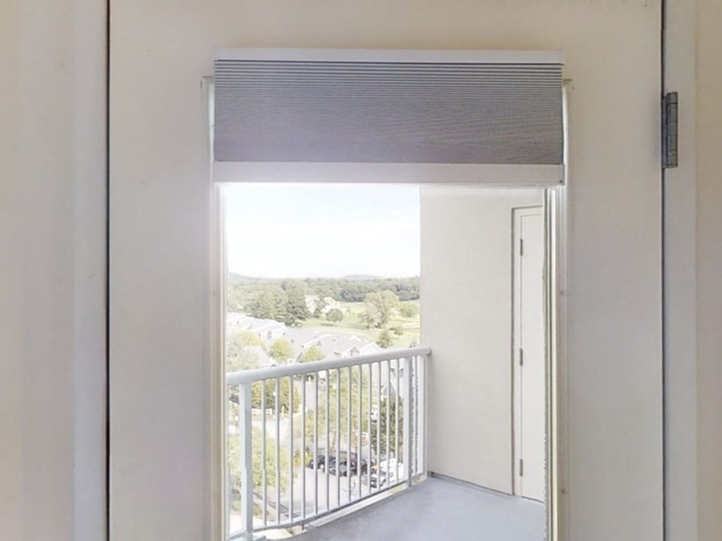 36 Village Road, Unit 713 Middleton, MA 01949 - Photo 17 of 39 a view of a glass door and a yard from a corridor