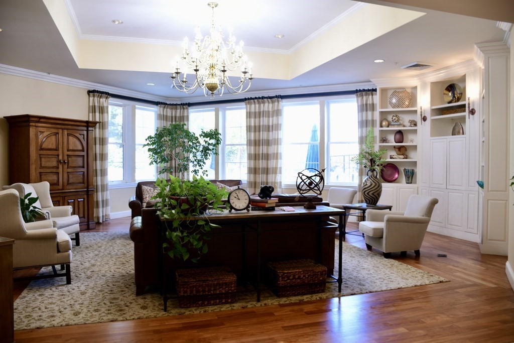 36 Village Road, Unit 713 Middleton, MA 01949 - Photo 26 of 39 a living room with furniture and a chandelier