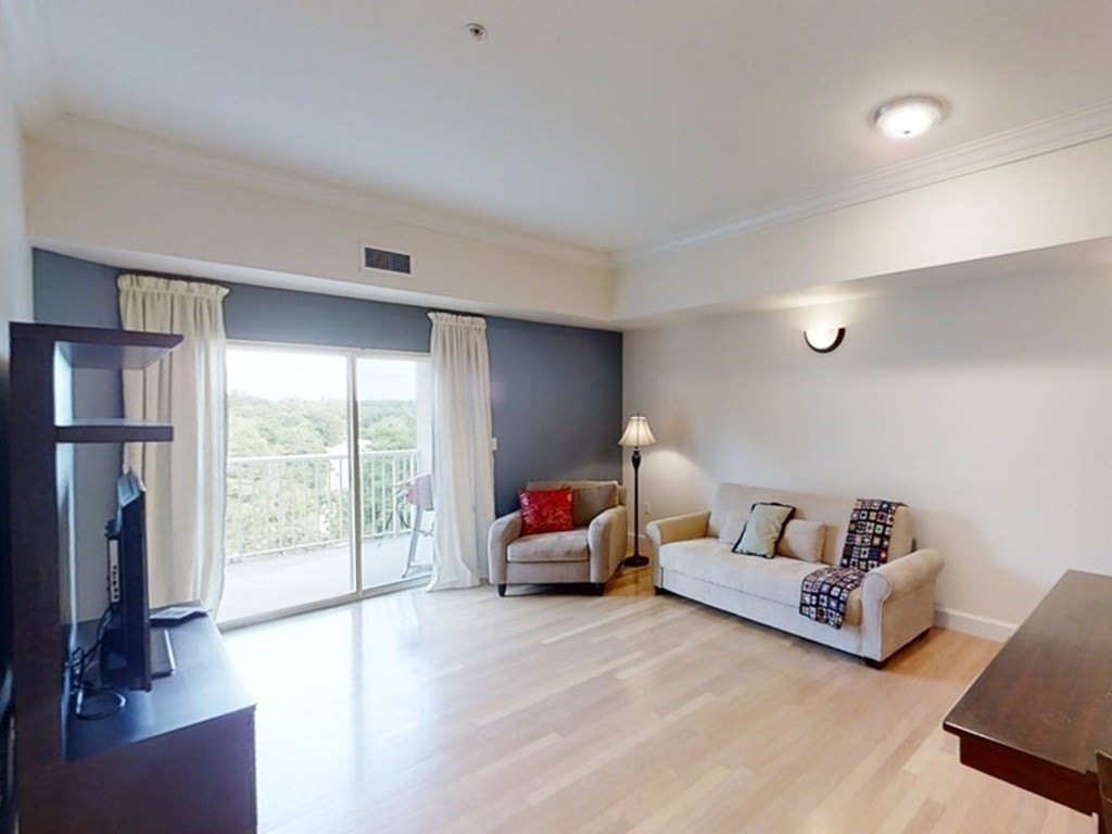 36 Village Road, Unit 713 Middleton, MA 01949 - Photo 5 of 39 a living room with furniture and a flat screen tv