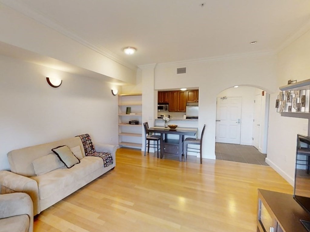 36 Village Road, Unit 713 Middleton, MA 01949 - Photo 6 of 39 a living room with furniture a flat screen tv and a fireplace