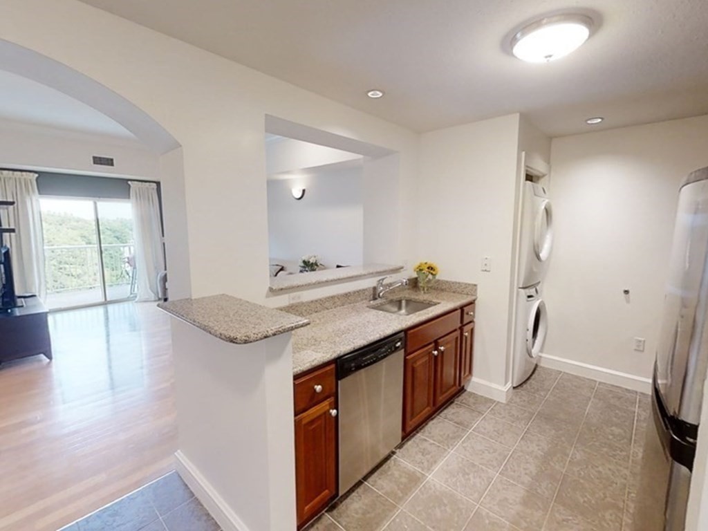36 Village Road, Unit 713 Middleton, MA 01949 - Photo 8 of 39 a spacious bathroom with a granite countertop sink and a mirror