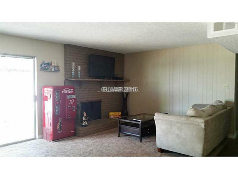 301 Lakehurst Road Las Vegas, NV 89145 - Photo 9 of 12 Family Room. Family room with fireplace over looking pool