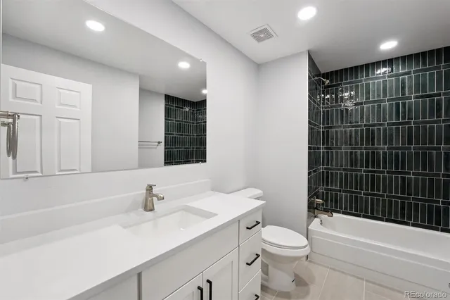 a bathroom with a sink a toilet and mirror
