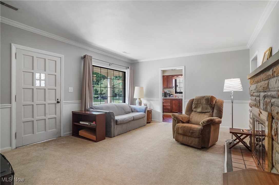 2829 Lee Road Silver Lake, OH 44224 - Photo 2 of 30 Carpeted living room featuring a fireplace and ornamental molding