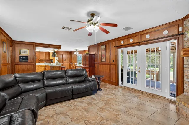 a living room with furniture ceiling fan and a rug