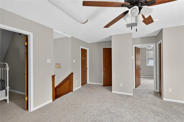 a view of empty room with ceiling fan