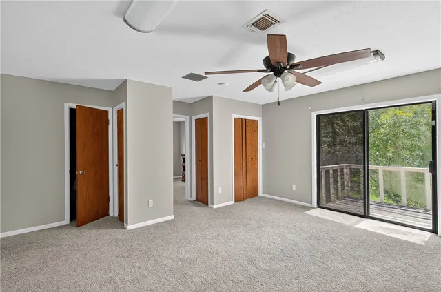 a view of a livingroom with a ceiling fan and window