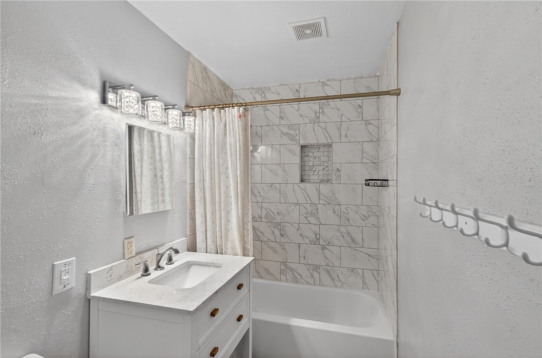 3501 Broad Oak Circle Bryan, TX 77802 - Photo 20 of 28 Full bath with a textured wall, shower / tub combo with curtain, and vanity