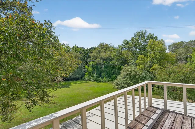 a balcony with trees in the background