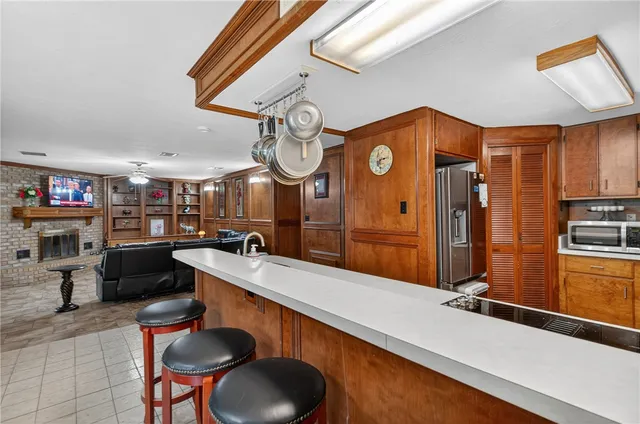 a large kitchen with a large counter space and stainless steel appliances