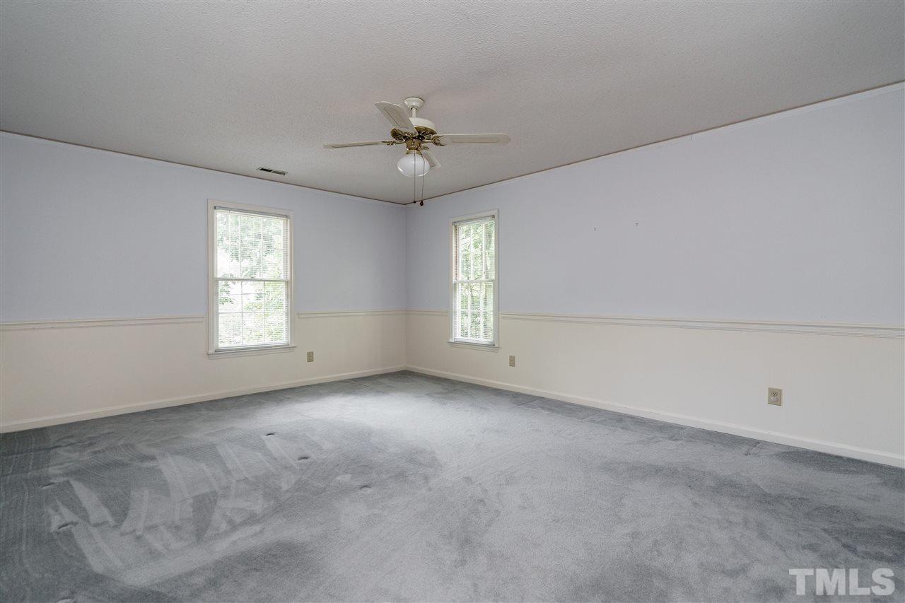 2524 Beechridge Road Raleigh, NC 27608 - Photo 14 of 26 an empty room with windows and ceiling fan