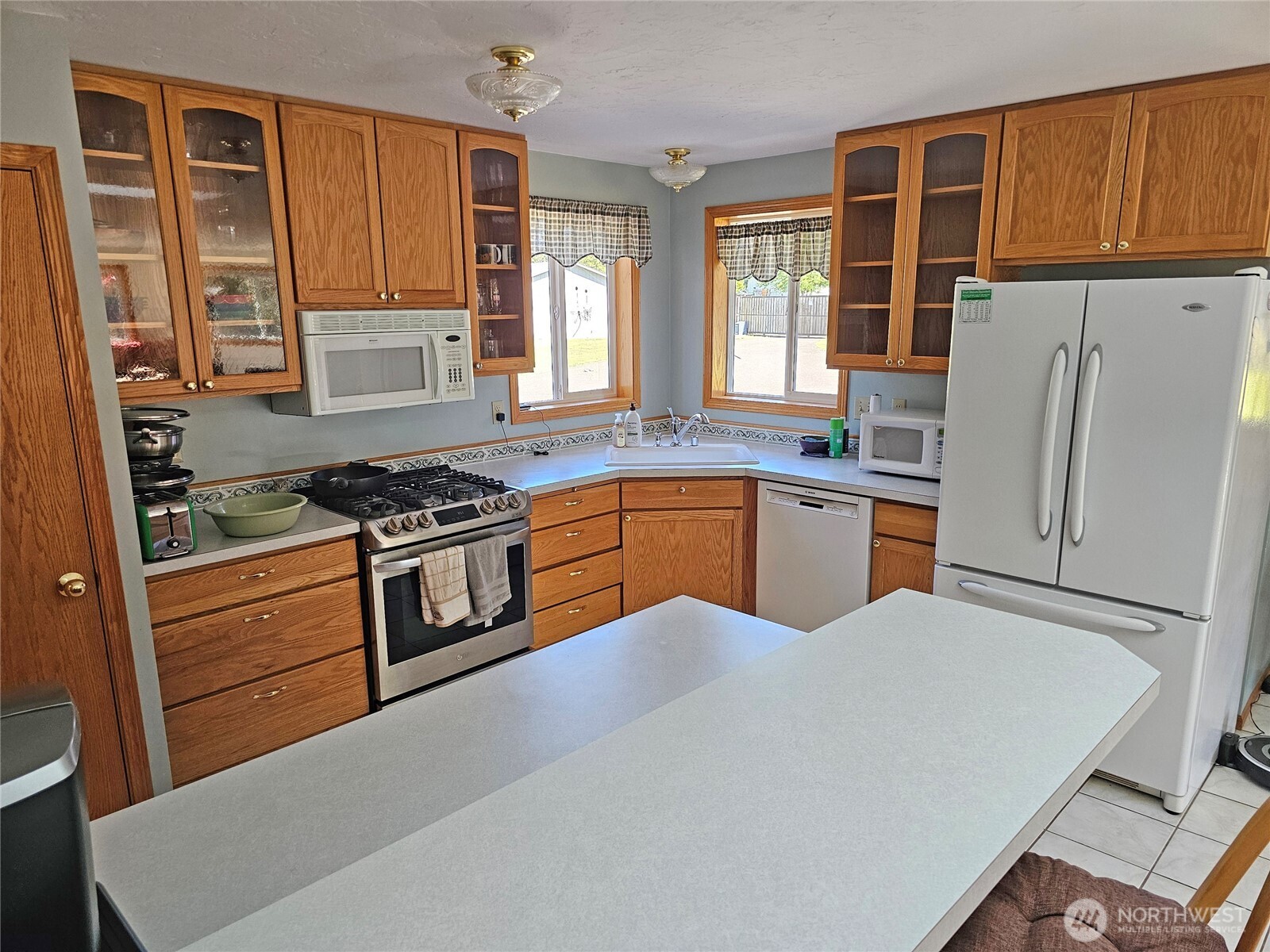 17103 Camas Run Lane Southwest Rochester, WA 98579 - Photo 8 of 40 a kitchen with stainless steel appliances granite countertop a stove a refrigerator and a sink