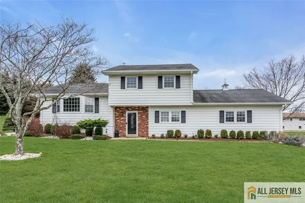a front view of a house with a garden and yard