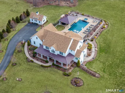 an aerial view of a house with a garden and swimming pool