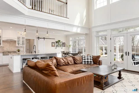 a living room with furniture window and wooden floor