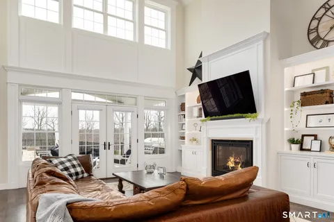 a living room with furniture a flat screen tv and a fireplace