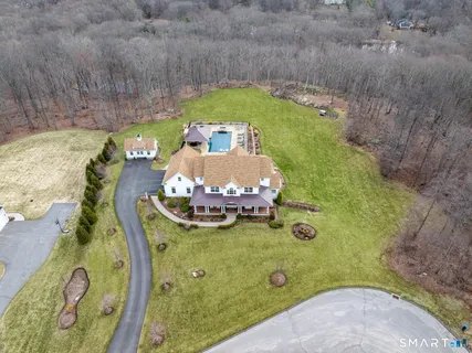 an aerial view of a house with a yard