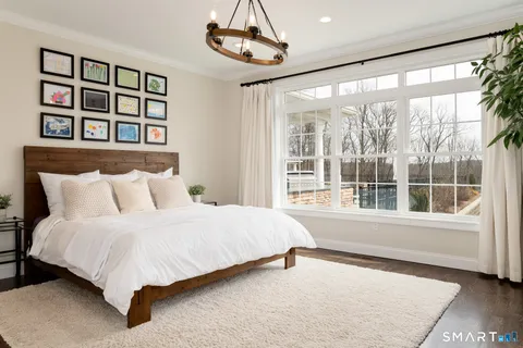 a bedroom with a large bed and a large window