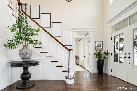 a view of entryway and hall with wooden floor