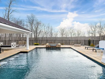 a view of a swimming pool with a lounge chair