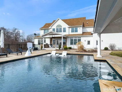 a view of a swimming pool and lounge chair