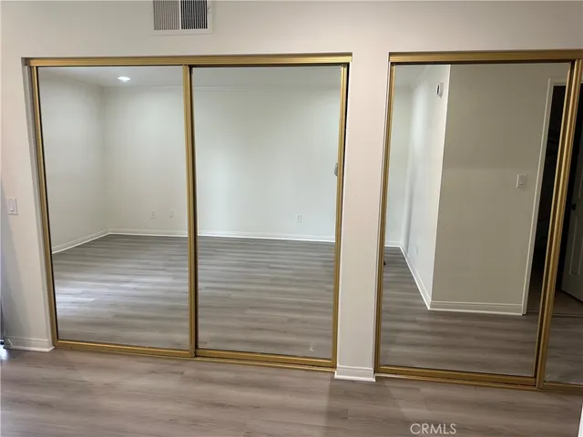 an empty room with wooden floor