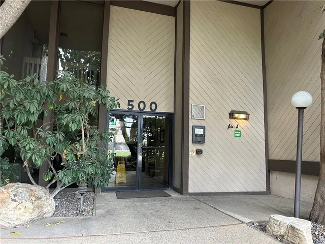 a view of a house with potted plants