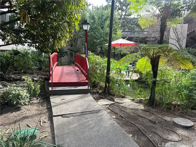 a backyard of a house with table and chairs potted plants