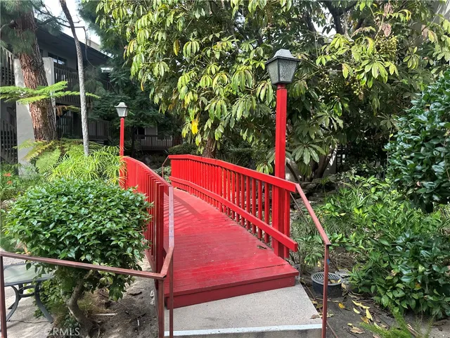 a view of a park with plants and wooden fence