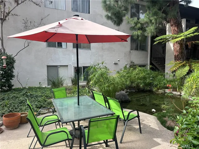 a view of table and chairs under an umbrella