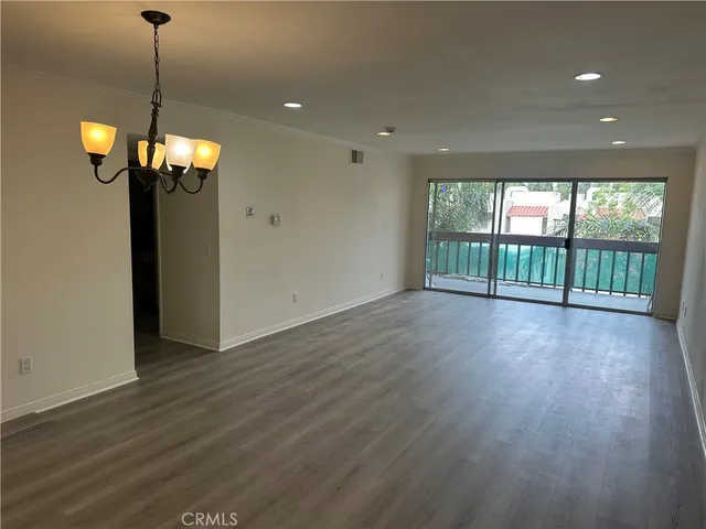 a view of a livingroom with a furniture wooden floor and windows