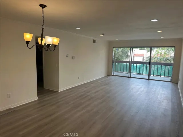 a view of a livingroom with furniture wooden floor and windows