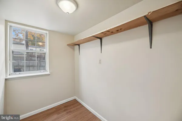 a view of a room with wooden floor and windows