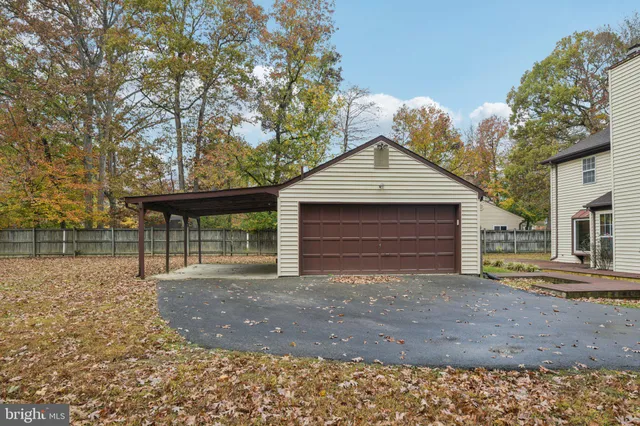 a view of backyard with wooden fence