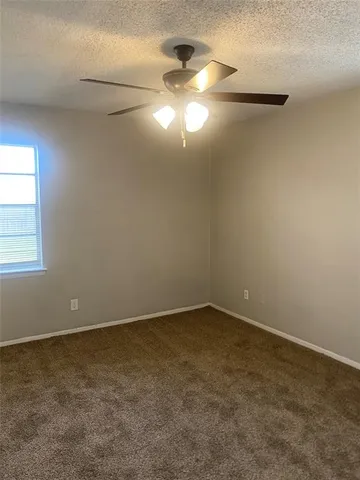 an empty room with a empty space and windows