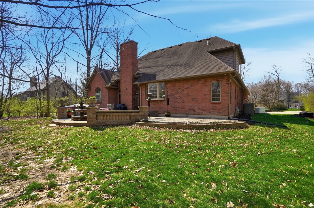 472 Timber Walk Court Springboro, OH 45066 - Photo 68 of 86 This residence features a timeless brick exterior complemented by a spacious patio, ideal for outdoor gatherings.