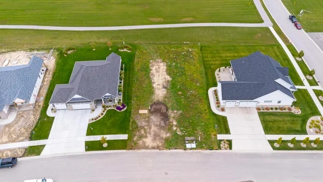 an aerial view of ocean with residential house