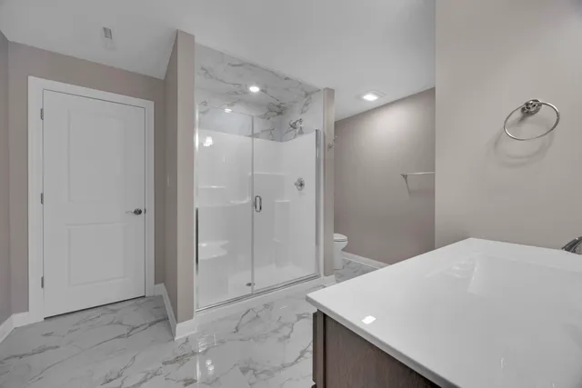 a bathroom with a shower and toilet