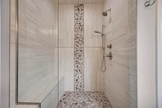 a bathroom with a sink a toilet and large mirror