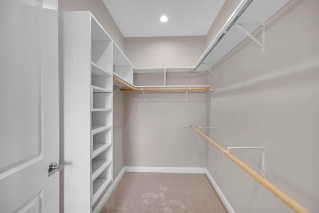 an empty room with windows and chandelier fan