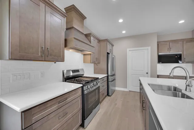 a kitchen with a sink stove and refrigerator