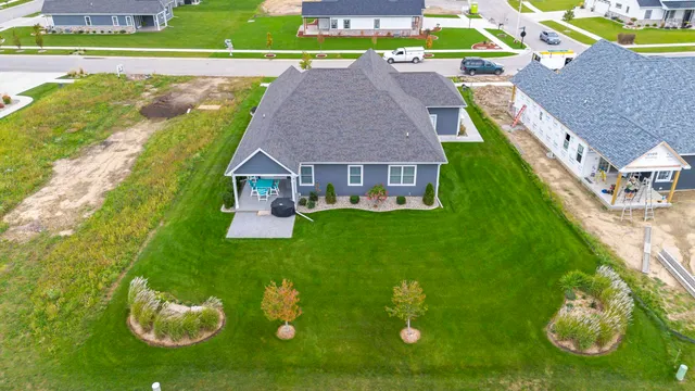 a aerial view of a house with swimming pool and next to a yard