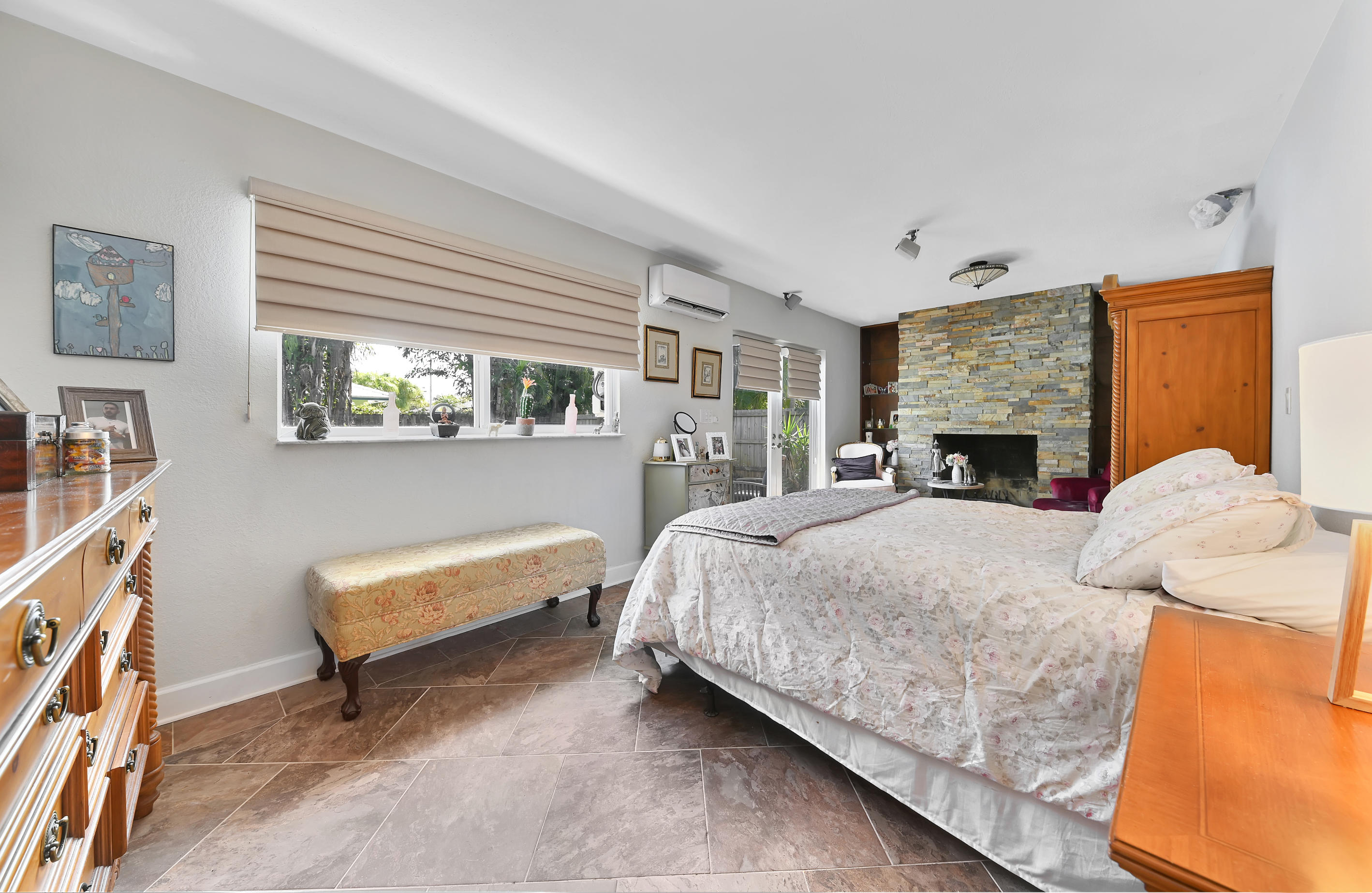 242 Northwest 12th Avenue Boca Raton, FL 33486 - Photo 8 of 13 a bedroom with a bed and dresser with mirror