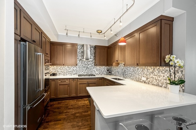 744 North Clark Street, Unit 801 Chicago, IL 60654 - Photo 2 of 12 a kitchen with a sink and refrigerator