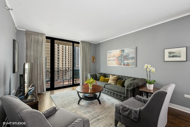 744 North Clark Street, Unit 801 Chicago, IL 60654 - Photo 4 of 12 a living room with furniture and a large window