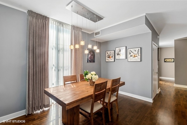 744 North Clark Street, Unit 801 Chicago, IL 60654 - Photo 5 of 12 a view of a dining room with furniture and wooden floor