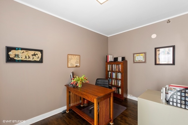 744 North Clark Street, Unit 801 Chicago, IL 60654 - Photo 6 of 12 a room with furniture and paintings on the wall