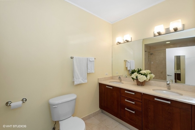 744 North Clark Street, Unit 801 Chicago, IL 60654 - Photo 8 of 12 a bathroom with a toilet a sink and mirror