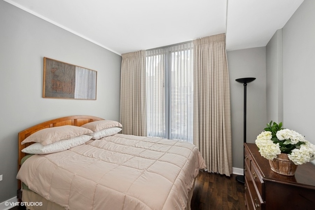 744 North Clark Street, Unit 801 Chicago, IL 60654 - Photo 9 of 12 a bedroom with a bed and a window