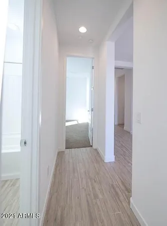 an empty room with windows and closet